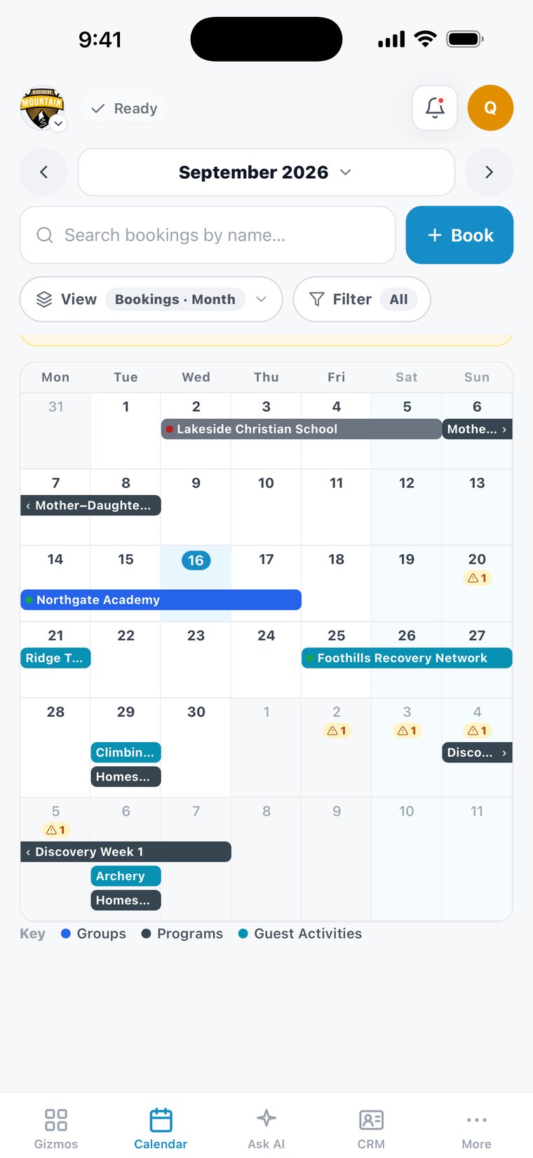 The One App on a phone — the Bookings Calendar at Discovery Mountain, a September of group stays, programs and activities